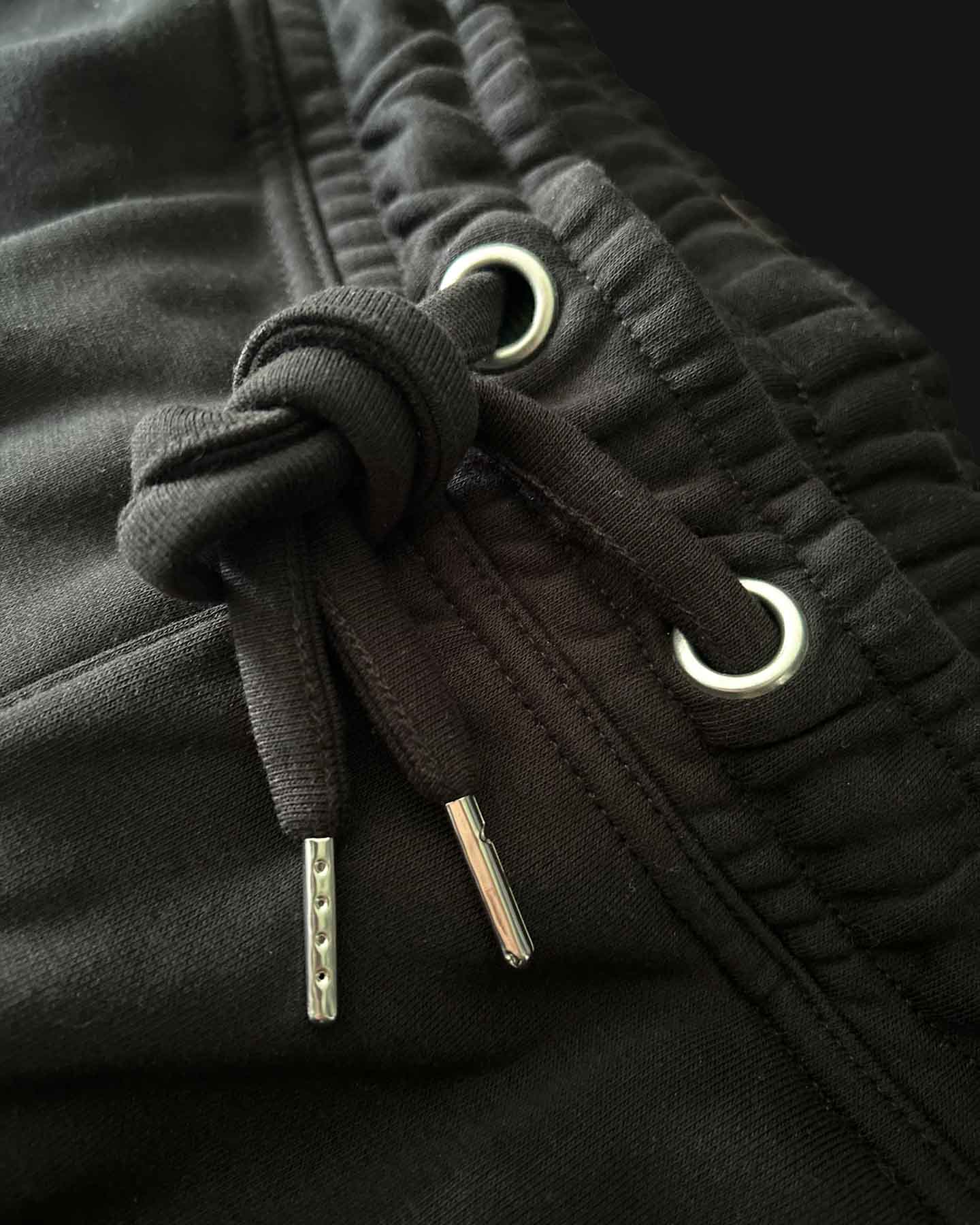 Detailed close-up of drawstrings on black Essentials Men's Casual Jogger Shorts, highlighting quality and design